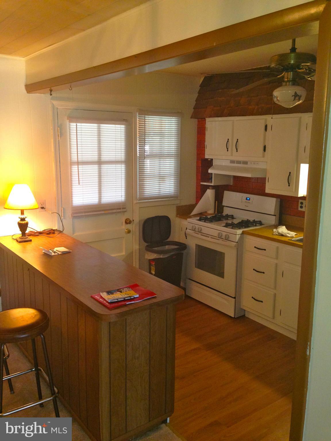 2739 Kirkleigh Road Baltimore, MD 21222 - Photo 9 of 30 a kitchen with a stove a sink and a refrigerator