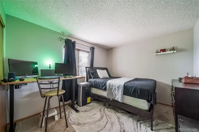 a bedroom with furniture and a flat screen tv