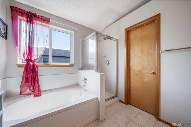 a bathroom with a bathtub and shower