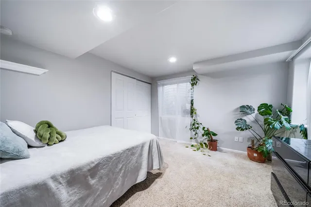 a bedroom with a bed and a potted plant