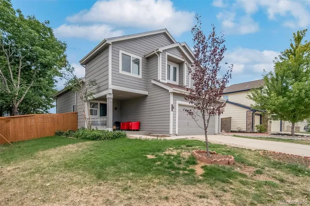 a front view of house with yard and trees