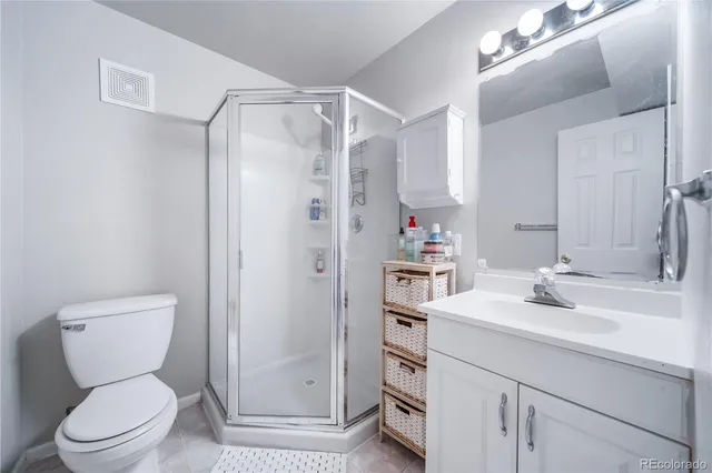 a bathroom with a sink toilet vanity and shower