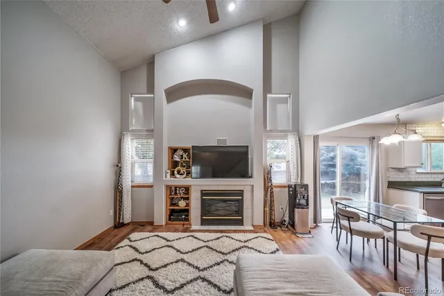 a bedroom with furniture a fireplace and a flat screen tv