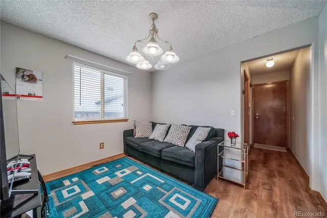 a living room with furniture and a baby crib