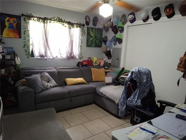 a living room with furniture and a large window