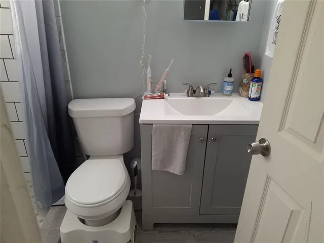 a white toilet sitting next to a bathroom sink