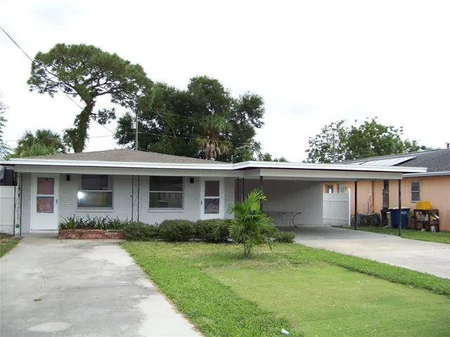 a front view of house with yard and green space