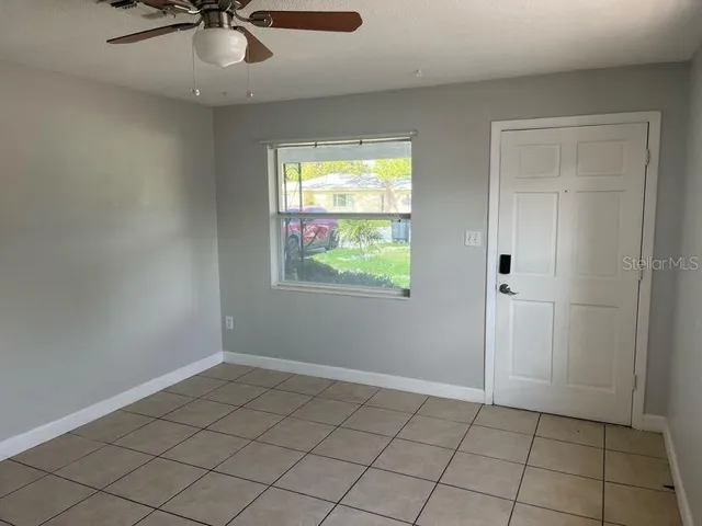 a kitchen with cabinets stainless steel appliances and a window