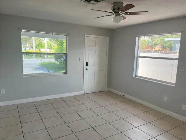 a view of a house with a backyard and plants