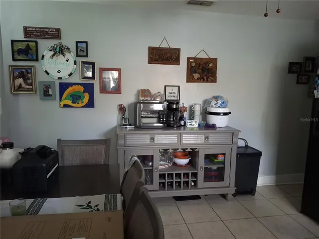 a room with computer and a shelf