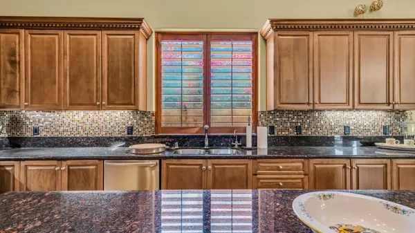 a view of a patio with table and chairs and floor to ceiling window