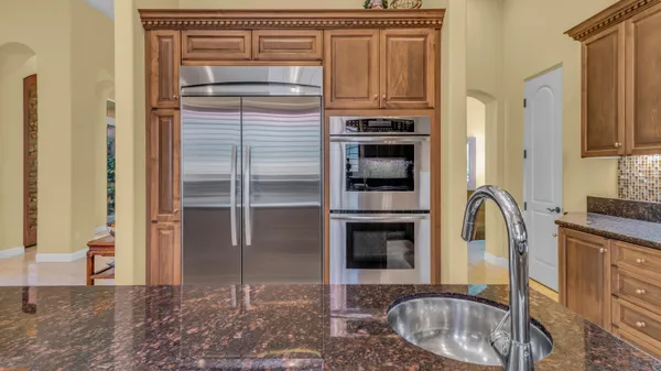 a view of a patio with iron fence