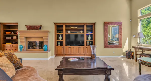 a living room with furniture a fireplace and a flat screen tv