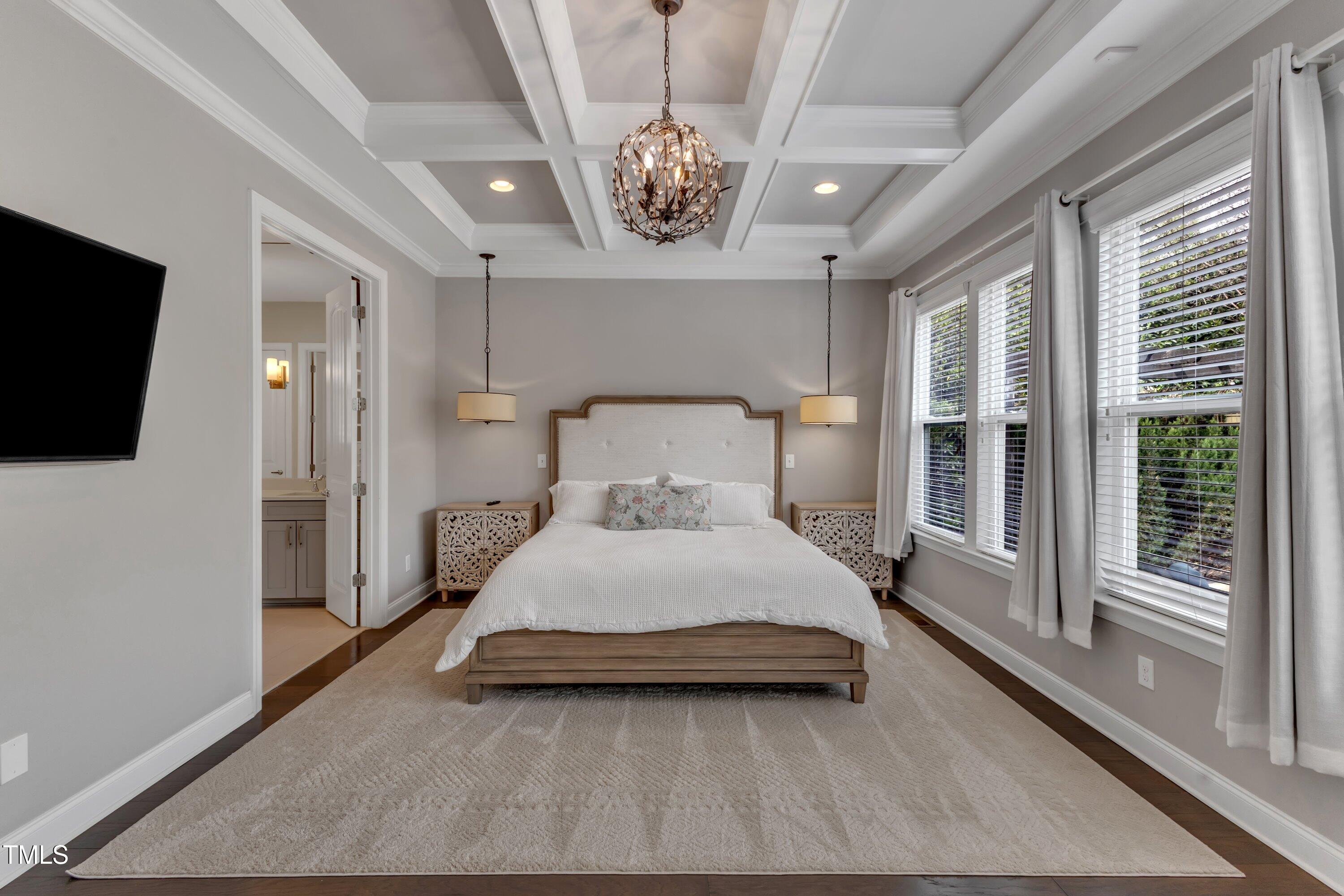 8121 Greys Landing Way Raleigh, NC 27615 - Photo 28 of 95 a bedroom with a bed and a flat screen tv