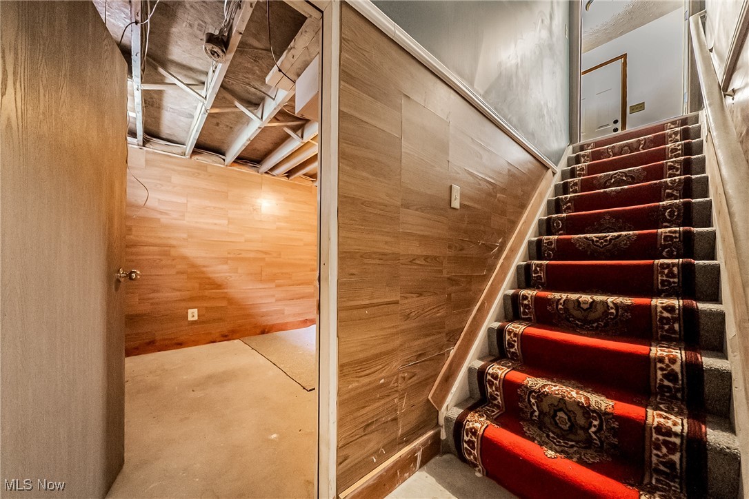 761 Garfield Street Akron, OH 44310 - Photo 24 of 31 Staircase with concrete floors and wood walls