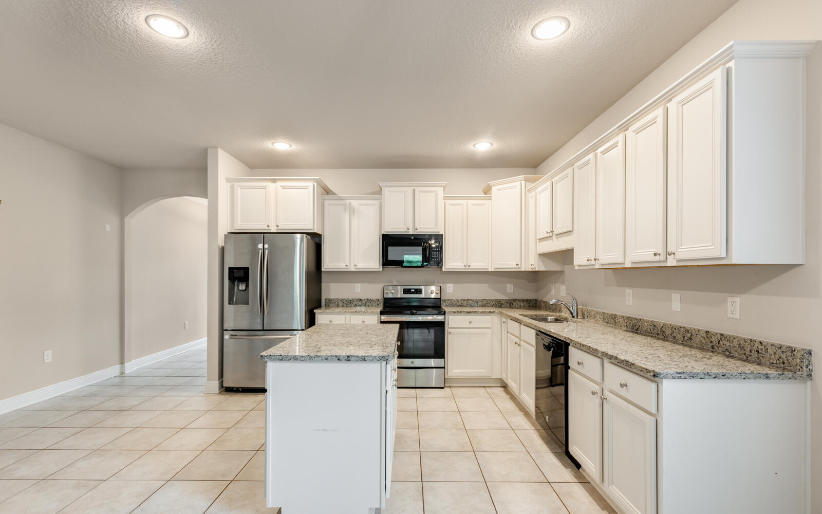 379 Whitman Way Freeport, FL 32439 - Photo 13 of 97 a kitchen with stainless steel appliances granite countertop a refrigerator sink and cabinets