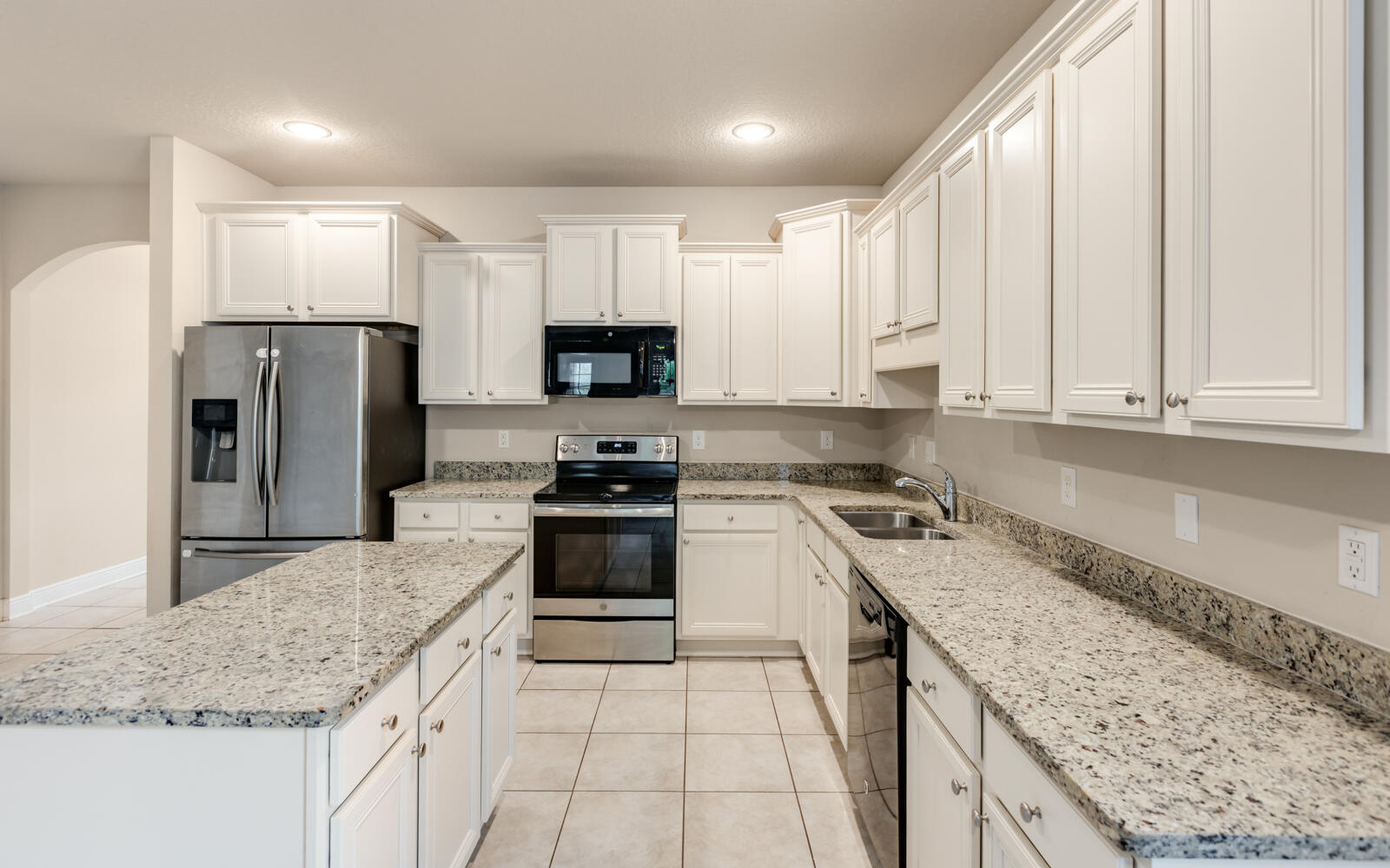 379 Whitman Way Freeport, FL 32439 - Photo 15 of 97 a kitchen with stainless steel appliances granite countertop a sink stove refrigerator and cabinets