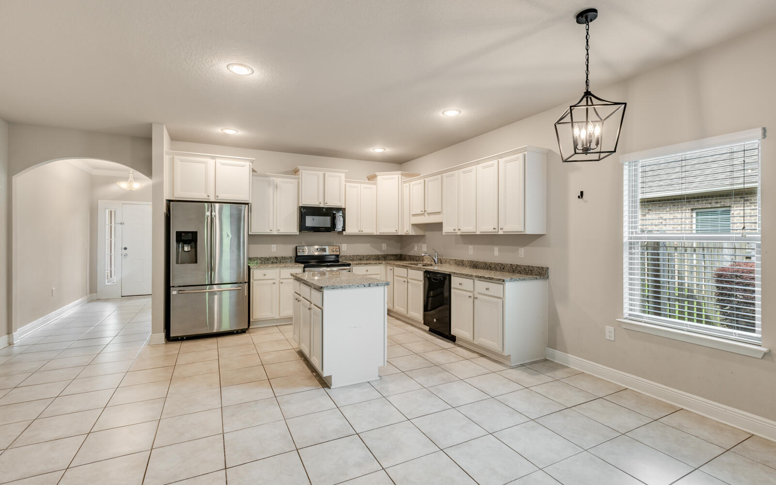 379 Whitman Way Freeport, FL 32439 - Photo 19 of 97 a kitchen with stainless steel appliances granite countertop a refrigerator a sink dishwasher a stove and white cabinets with wooden floor