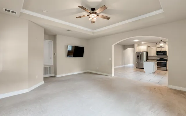 a view of a room with a window and a ceiling fan
