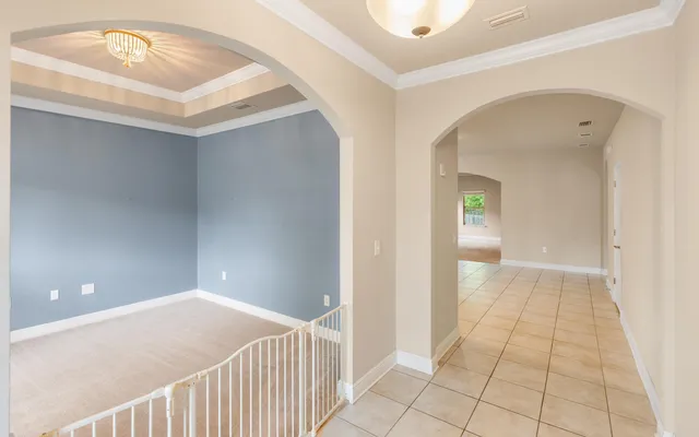 a kitchen with white cabinets stainless steel appliances and a window