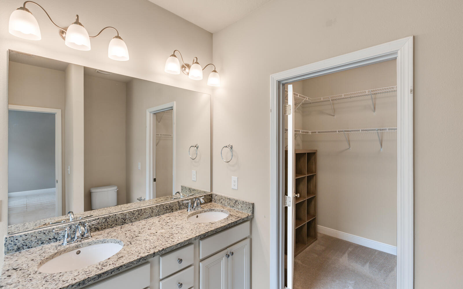 379 Whitman Way Freeport, FL 32439 - Photo 36 of 97 a bathroom with a granite countertop sink and a mirror