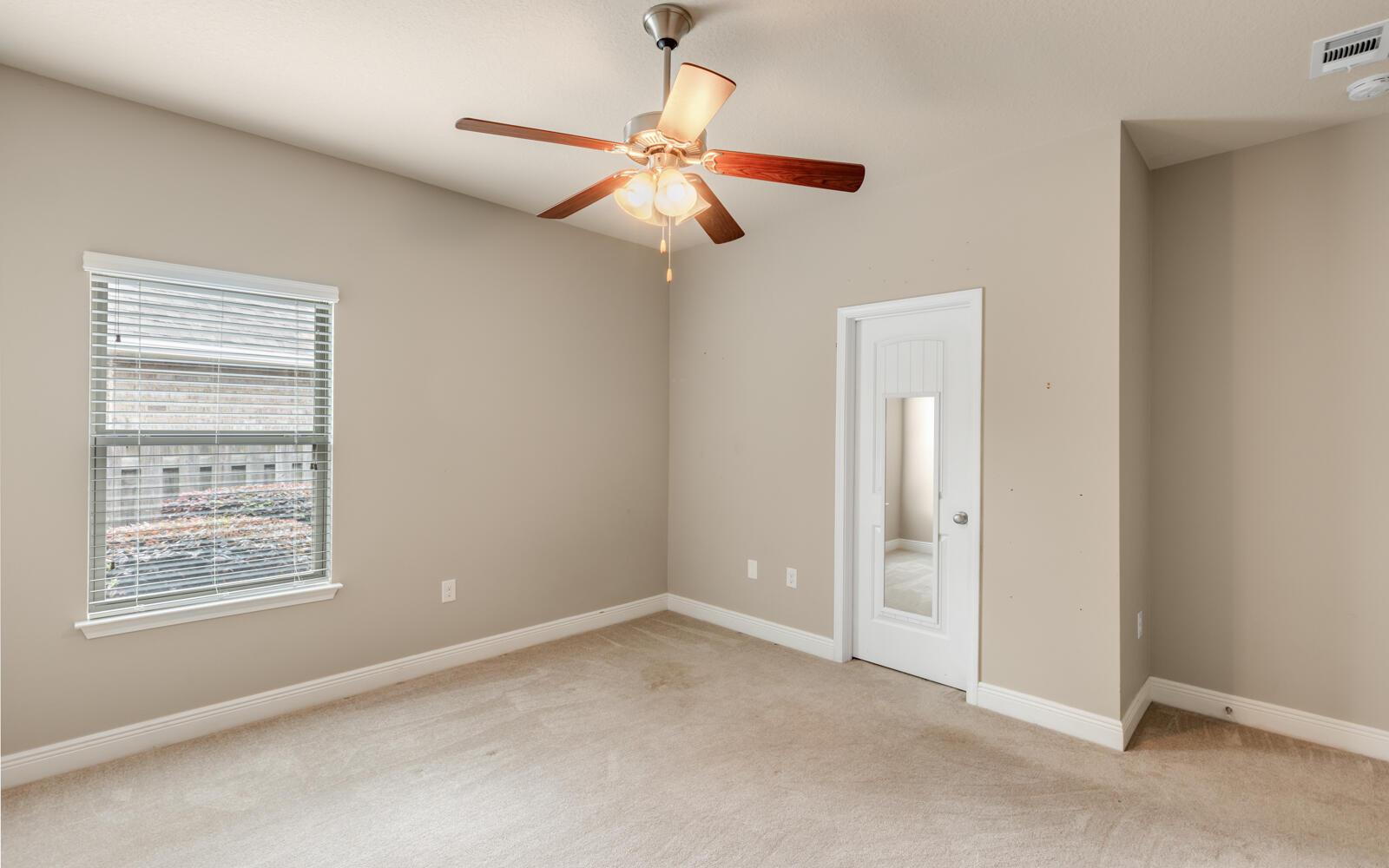 379 Whitman Way Freeport, FL 32439 - Photo 41 of 97 an empty room with windows and fan