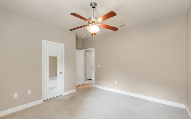 a view of a big house with a big yard and potted plants