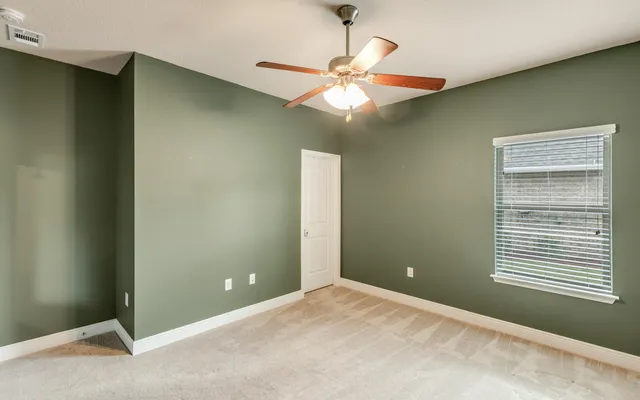 a living room with furniture a flat screen tv and a large window