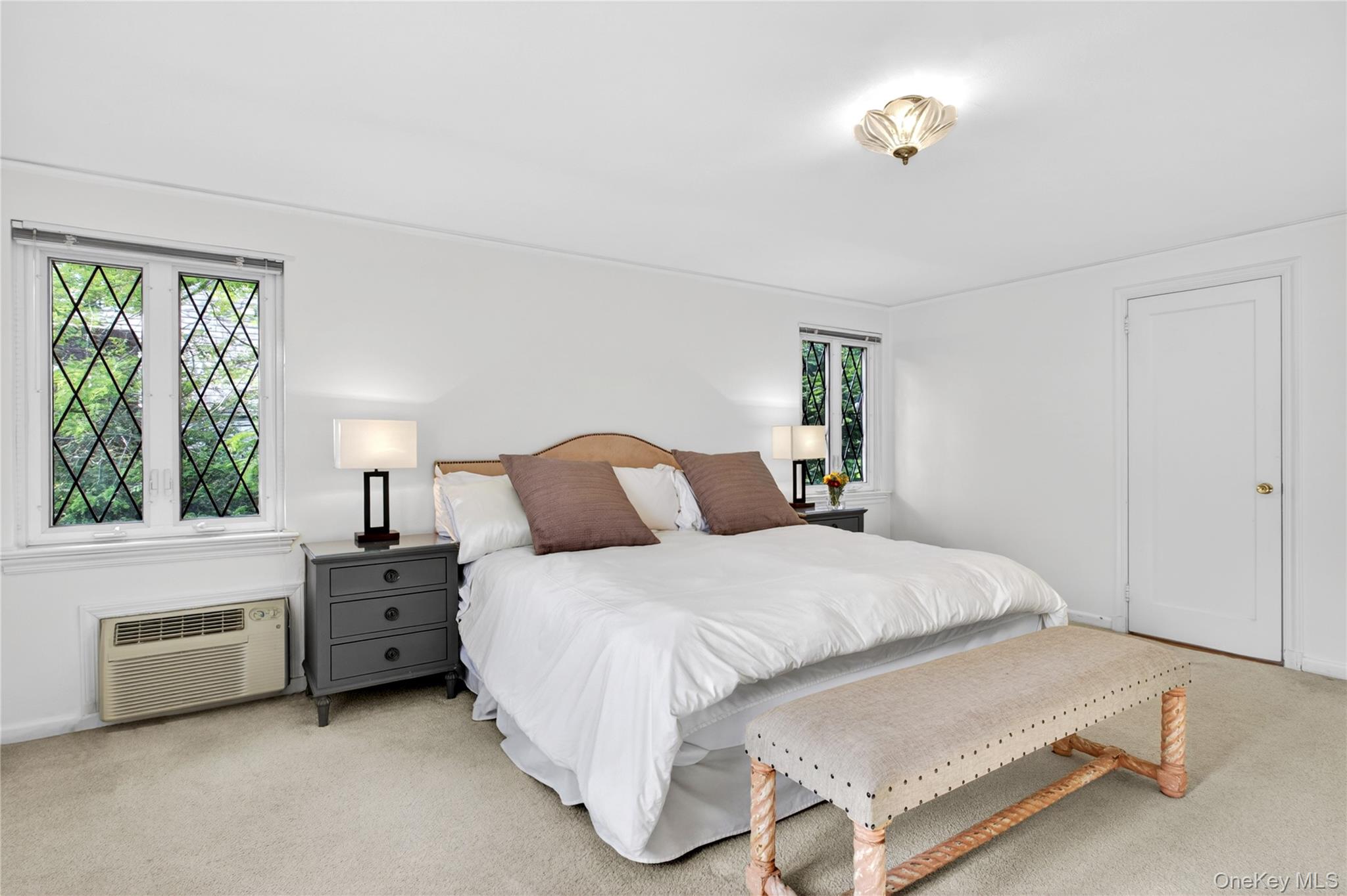 142 Mill Spring Road Manhasset, NY 11030 - Photo 16 of 23 a bedroom with a bed dresser and a window