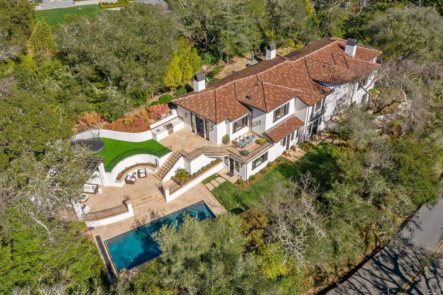 an aerial view of a house with a yard and garden