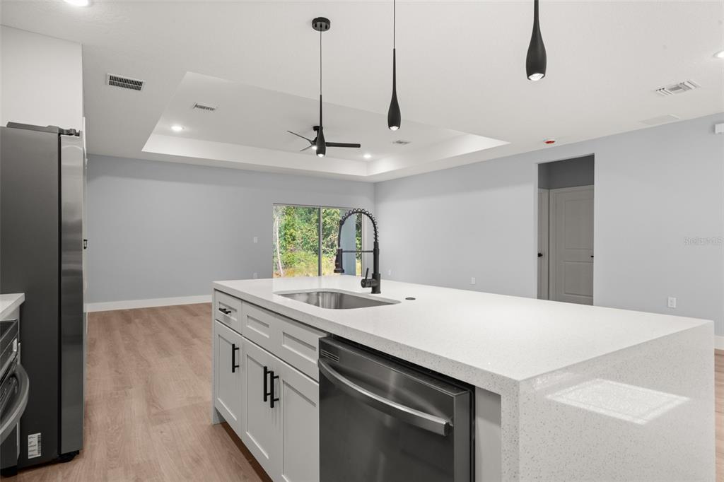 8736 Capilla Street Sebring, FL 33872 - Photo 17 of 60 a kitchen with a sink a stove and a refrigerator