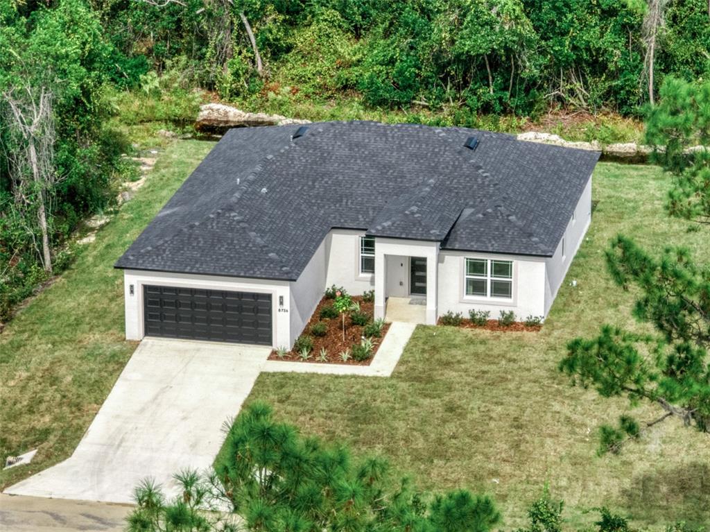 8736 Capilla Street Sebring, FL 33872 - Photo 2 of 60 front view of a house with yard
