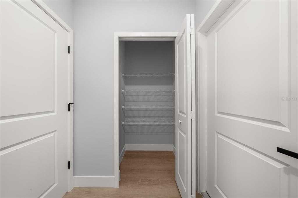 8736 Capilla Street Sebring, FL 33872 - Photo 23 of 60 a view of walk in closet with empty racks