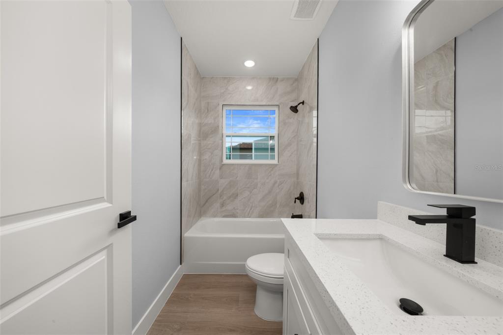 8736 Capilla Street Sebring, FL 33872 - Photo 41 of 60 a bathroom with a sink a toilet and shower