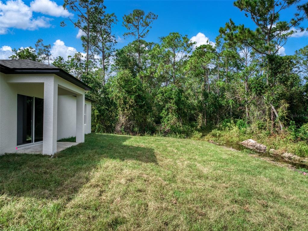 8736 Capilla Street Sebring, FL 33872 - Photo 53 of 60 a view of a wooden house with a yard