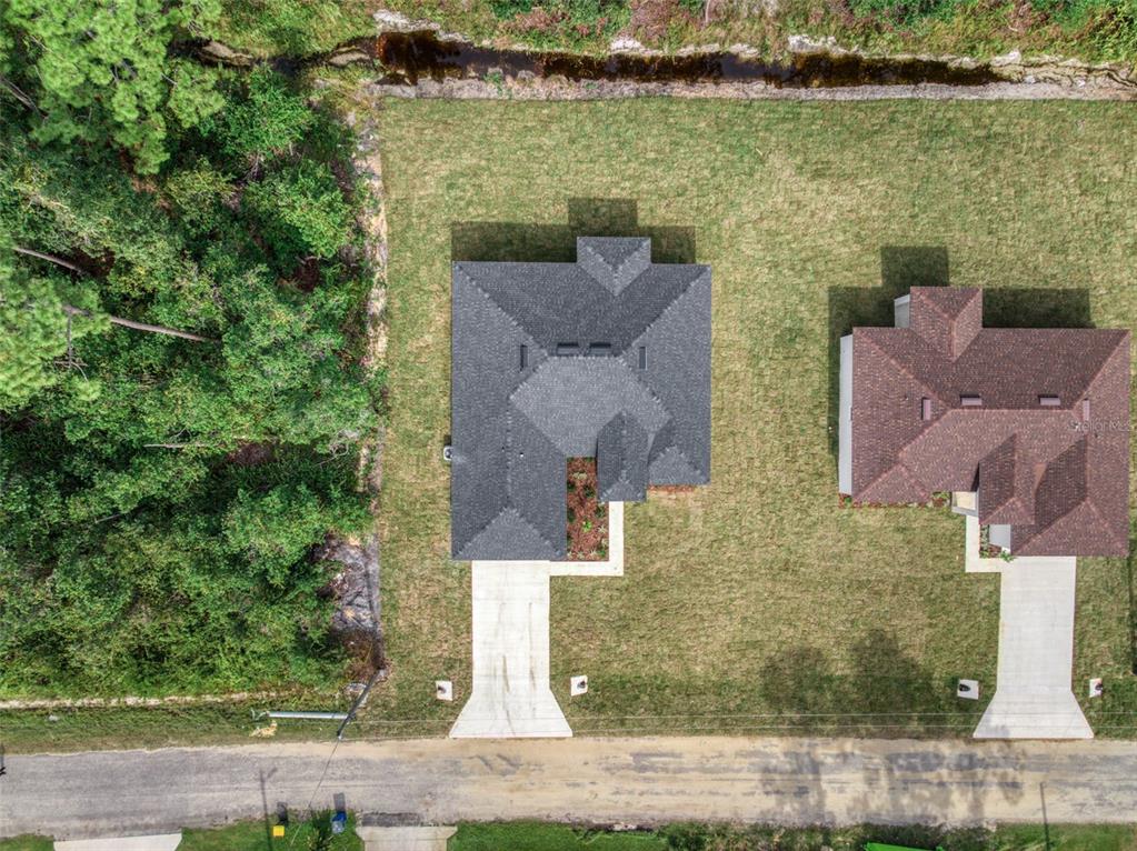 8736 Capilla Street Sebring, FL 33872 - Photo 60 of 60 an aerial view of a house with a yard and lake view