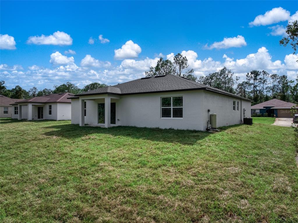8736 Capilla Street Sebring, FL 33872 - Photo 6 of 60 a view of a house with backyard