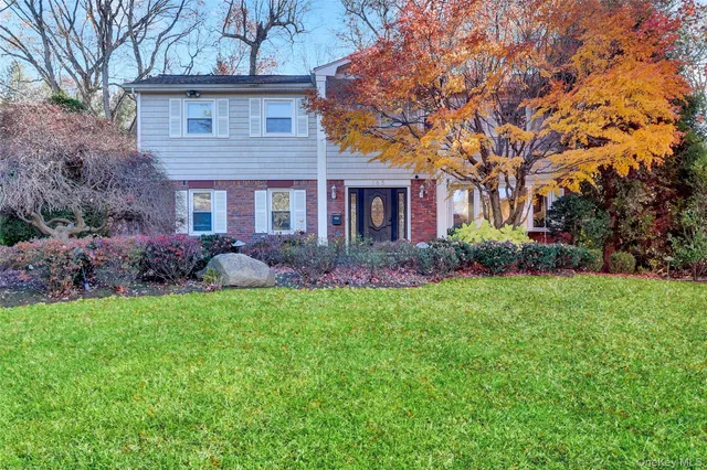 a front view of house with yard and green space