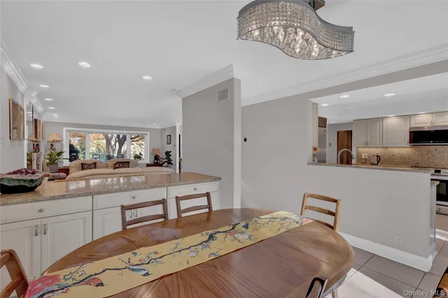 a kitchen with stainless steel appliances kitchen island granite countertop a sink and cabinets