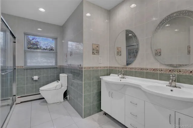 a bathroom with double sink and a mirror