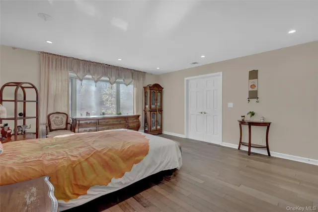 a spacious bedroom with a large bed and a dresser