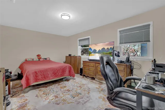 a bedroom with a bed and a desk