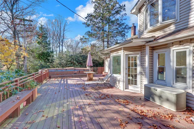 a view of a patio with table and chairs and wooden floor