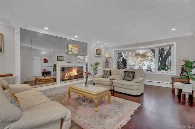 a living room with furniture fireplace and a large window