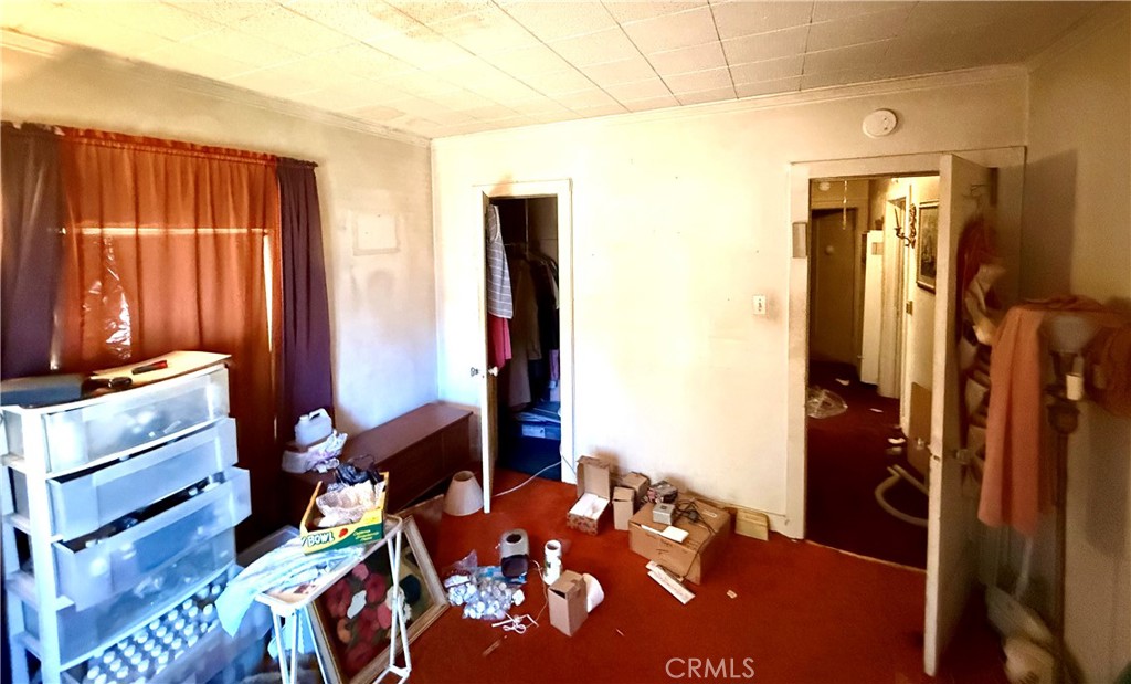 1317 South Temple Avenue Compton, CA 90221 - Photo 11 of 13 a bedroom with a bed and a dresser