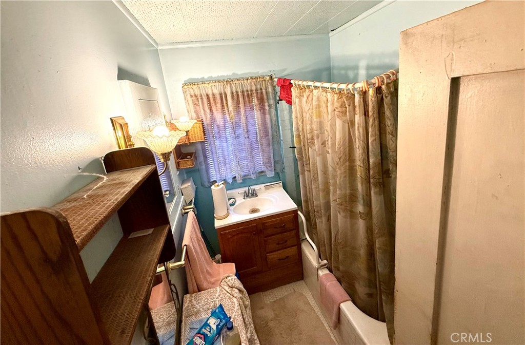 1317 South Temple Avenue Compton, CA 90221 - Photo 12 of 13 a view of walk in closet with clothes and shoes