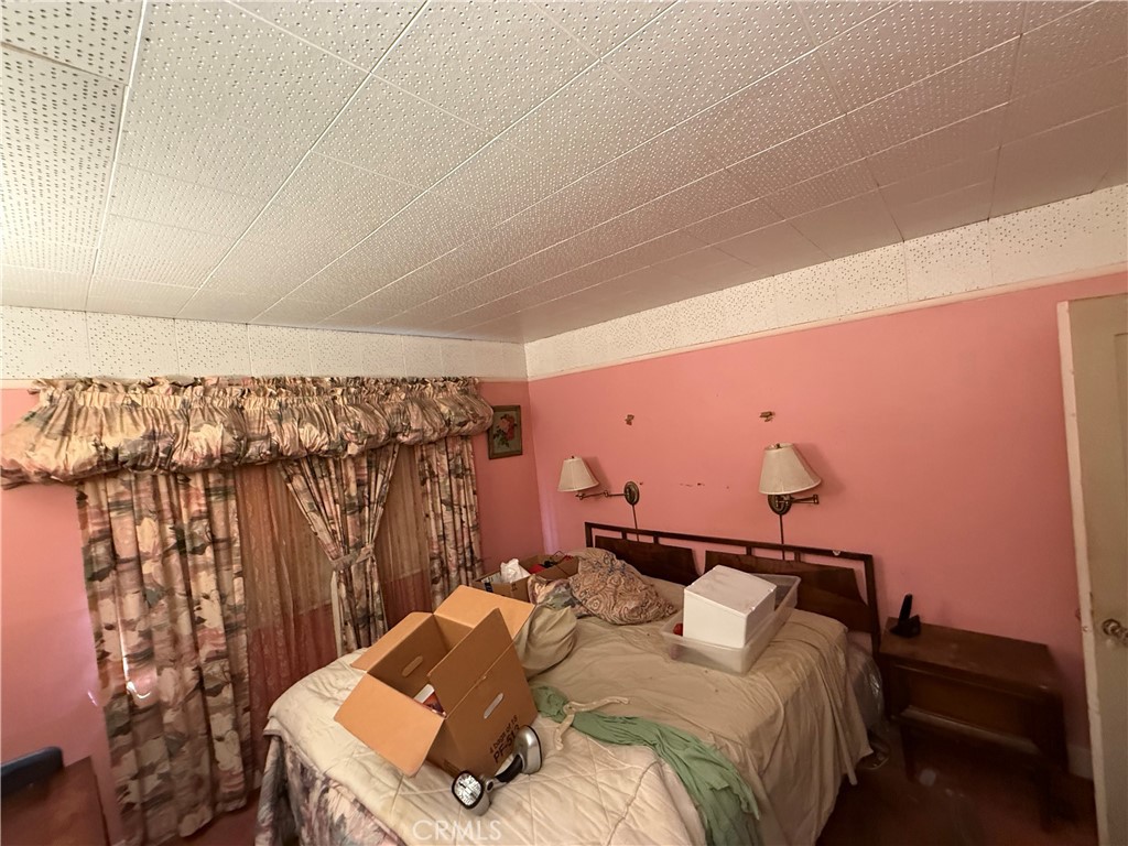1317 South Temple Avenue Compton, CA 90221 - Photo 8 of 13 a bedroom with a bed and a mirror