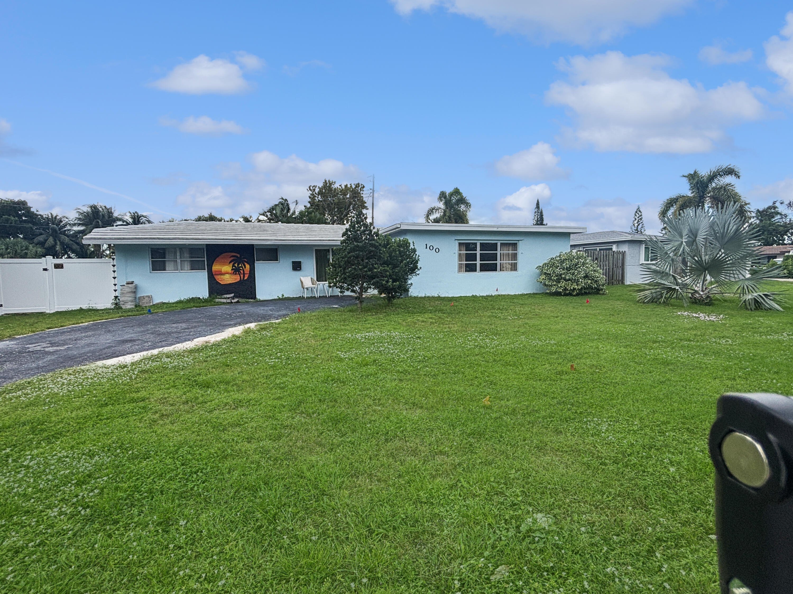 a view of a house with a yard and sitting area
