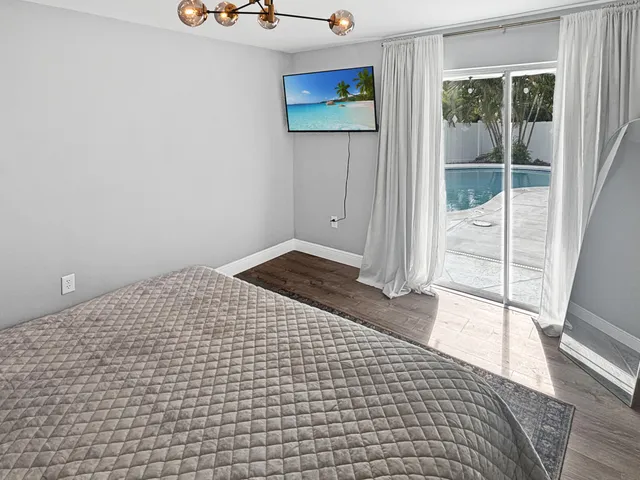 a view of a room with wooden floor and windows