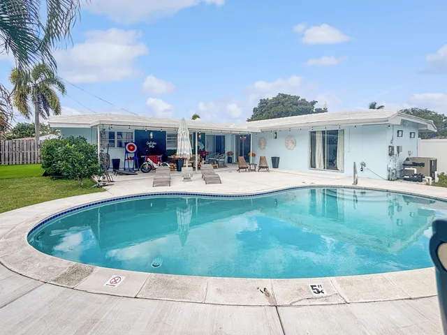 a view of a swimming pool with outdoor seating
